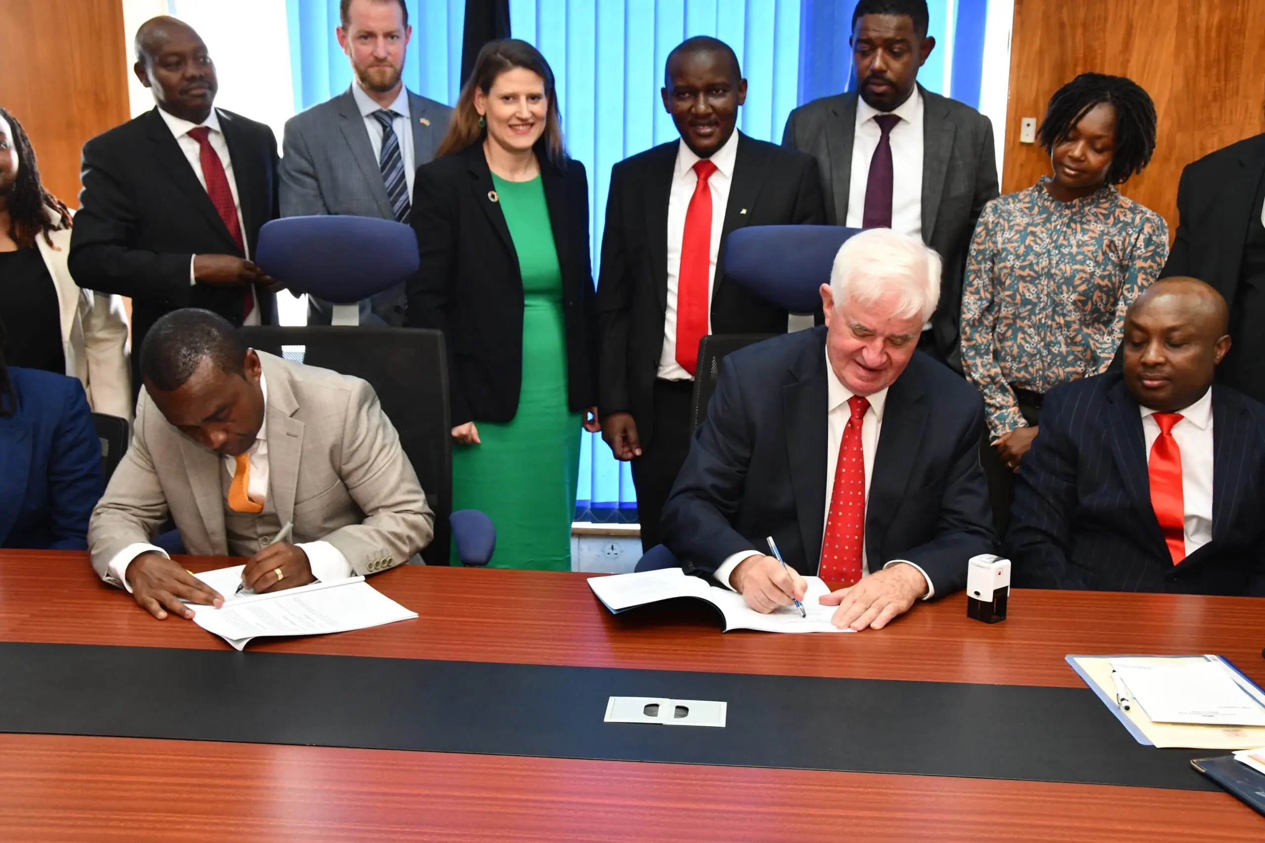 NIA CEO Eng Mwasia signing an agreement with British firm. Image: courtesy.